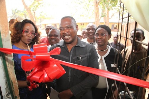 Enugu State Commissioner for Education, Professor Uche Eze cuts tape to unveil new resource centre as Caroline Oghuma (L), Public Relations Manager, DStv, looks on