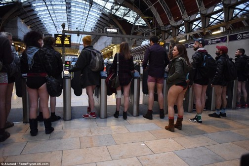 Hundreds of commuters at a London station get ready for their travels wearing coats, scarves and no trousers for the 'No Pants' ride