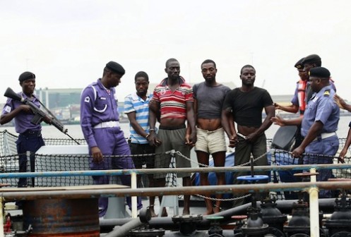 Suspected pirates are paraded aboard a naval ship after their arrest by the Nigerian Navy at a defence jetty in Lagos August 20, 2013. Commodore Chris Ezekobe, naval commander at the NNS Beecroft, a Lagos naval base, said the four had hijacked the barge and its crew on August 14 on the eastern edge of the Nigerian coast, near the port city of Calabar. REUTERS/Akintunde Akinleye (NIGERIA - Tags: CRIME LAW MARITIME)