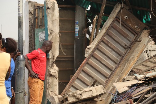 One of the shop owners look at what  remained of his shop after the demolition. Photo Credit Idowu Ogunleye