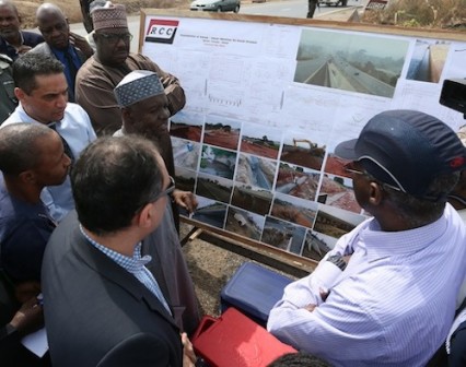 Hon. Minister of Power, Works and Housing, Mr Babatunde Fashola, SAN (right) and the Minister of State in the Ministry, Hon. Mustapha Baba Shehuri (left) being shown the progress of work on the on going Abuja-Abaji-Lokoja road by the Director, Federal Highways (North Central), Engr. A.M Gambo (2nd left) during the inspection, verification and fact finding tour of the Ministry's projects in the North Central Zone as part of the nationwide tour of projects on Monday, 25th January 2016