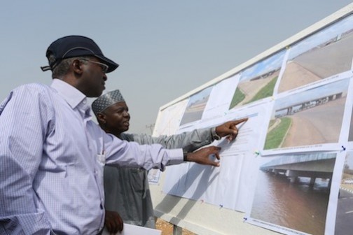  Hon. Minister of Power, Works & Housing, Mr Babatunde Fashola, SAN (right) being shown the progress of work on the ongoing Abuja-Abaji-  Lokoja road by the Director, Federal Highways (North Central) , Engr. A. M Gambo, during the inspection , verification and fact finding tour of the Ministry's projects in the North Central Zone as part of the nationwide tour of projects on Monday, 25th January 2016