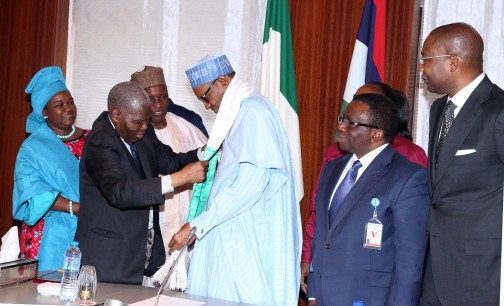  R-L; Former MD of Access Bank Plc, Mr. Aigboje Aig-Imoukhuede, Minister of Health, Mr Isaac Adewole, President Muhammadu Buhari being decorated bt the Former Nigerian High Commissioner to United Kingdom, Dr Christopher Kolade, Alhaji Muhammad Abubakar and Mrs Omotayo Omotosho during an audience with the President at the State House in Abuja. PHOTO; SUNDAY AGHAEZE. JAN 21 2016.