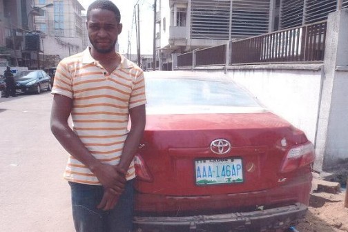 Suspected car thief, Mathias Isa with the Toyota Camry car he allegedly stole from Marina car park in Lagos and took to Kogi