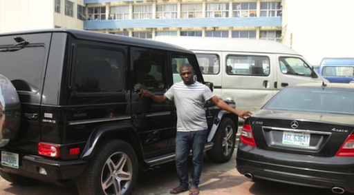 Hope Olusegun Aroke poses with his exotic cars EFCC