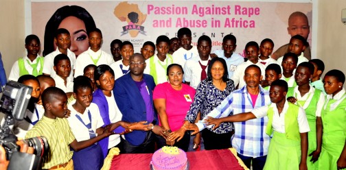 Guests help Foluke Daramola-Salako to cut her birthday cake