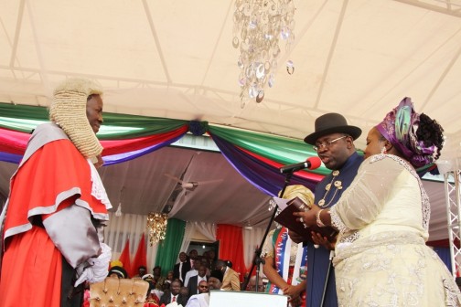  Chief Judge of Bayelsa State, Hon. Justice Kate Abiri (left) administering the oath of office on Hon. Seriake Dickson, (2nd right)  supported by his wife, Rachael (right) during his swearing-in for a 2nd term as Governor of Bayelsa State at the Samson Siasia Sports Complex in Yenagoa. Photo by Lucky Francis