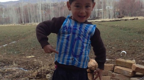 Murtaza Ahmadi wears a plastic jersey with Lionel Messi's name and number written on it