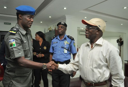 Governor Oshiomhole congratulating Mr Ibrahim Abdullahi after being decorated with a new rank 