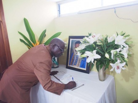Ayo Opadokun signing the condolence registar