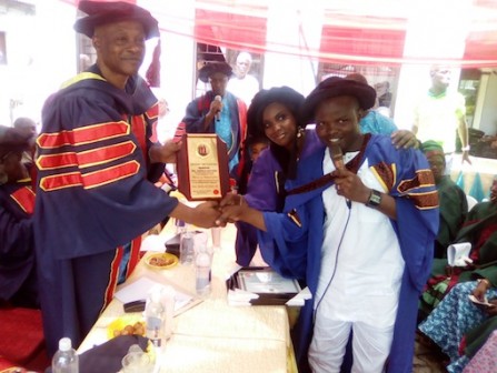 Hon. Lookman Omotosho, the Executive Secretary of Lagos Island East LCDA, presenting an award to a beneficiary of the scheme