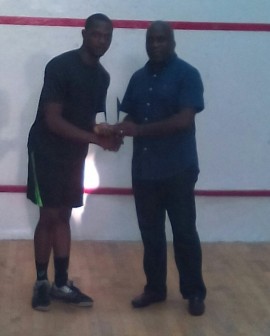 Chairman Lagos State Sports Commission, Mr Deji Tinubu (right) presents winner's trophy to Wale Amao who won the men event.  