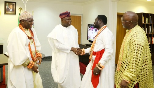 Lagos State Governor, Mr. Akinwunmi Ambode (2nd left), in a warm handshake with Chief Emami Ayirimi (2nd right) while Olu of Warri, King Godfrey Ikenwoli Emiko, Ogiame Ikenwoli I (left) and President, Nigeria Football Association (NFA), Mr. Amaju Pinnick (right) watch with admiration, during a courtesy visit to the Governor by the Olu of Warri, at the Lagos House, Ikeja on Monday, March 14, 2016.