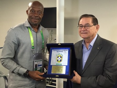 President of the Brazilian Football Federation presenting a plaque to deputy general secretary of NFF, Dr. Emmanuel Ikpeme