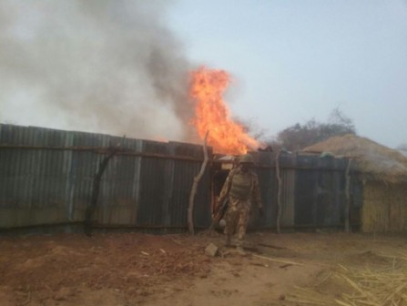 FILE PHOTO: Nigerian troops burn down a Boko Haram hideout