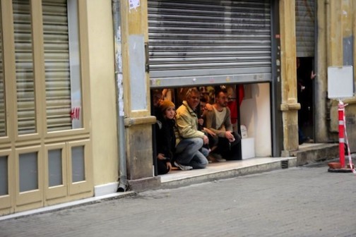 People take shelter inside a shop after an explosion on the pedestrian Istiklal avenue in Istanbul on March 19, 2016 (AFP Photo/Bulent Kilic)