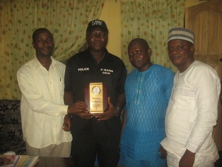 CSP Gbenga Megbope presented with the award by Charles Ojo (L)