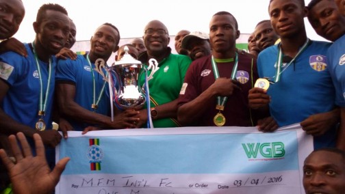 Chairman of Lagos State Football Association, Seyi   Akinwumi (middle) presents the Lagos FA Cup trophy to MFM FC players  at  the Agege Stadium on Sunday