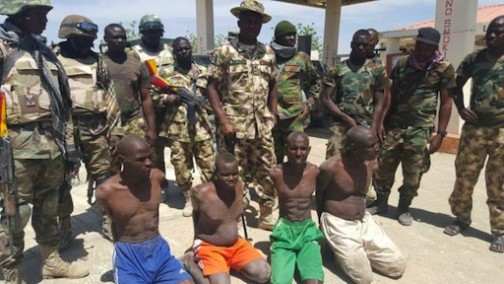Nigerian troops parade the arrested Boko Haram chieftains