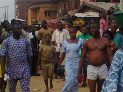SHOW OF SHAME: Inspector Ibrahim Odufarasin (bare chested and wearing only shorts)  and his  Onyabo Boys on Church Street in Ijora Badia
