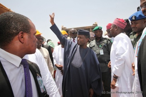 Governor Abdullahi Ganduje (R) looks on as Prof Yemi Osinbajo waves to the crowd