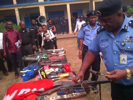 Mr. Ezike displaying some of the recovered arms from the suspects