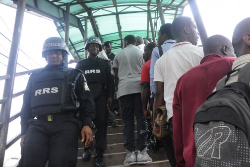 Commander, Rapid Response Squad, ACP Tunji Disu, leading his team to maintain peace and order on the usage of the Ojota Pedestrian Bridge, Lagos on Monday, April 11, 2016. 