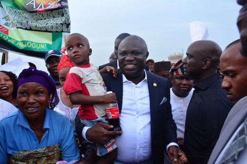 Lagos State Governor, Akinwunmi Ambode (middle); with a mother and child during his  inspection of the ongoing construction of Aboru-Abesan Link Road in Agbado/Oke Odo LCDA, Lagos, on Tuesday, April 12, 2016