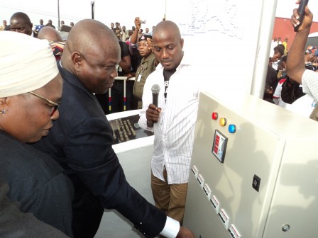 Lagos State Governor, Mr. Akinwunmi Ambode (middle), switching on the power circuit to light up the Lagos-Abeokuta Expressway (Ile Zik – Toll Gate, Sango Ota), during the commissioning the newly installed Street Light infrastructure, on Tuesday, April 12, 2016. With him is Executive Secretary, Ojokoro LCDA, Fausat Hassan-Olajoku (left)