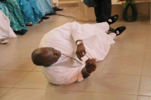 Senator Dino Melaye rolling on the floor in appreciation to God