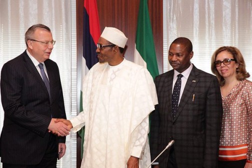 Executive Secretary of UNODC, Yury Fedotov shake hands with President Muhammadu Buhari