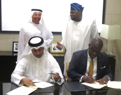 Lagos State Governor, Mr. Akinwunmi Ambode (right behind), with Deputy Prime Minister, United Arab Emirate (UAE) & Chairman, Dubai Holdings, Mr. Ahmad Bin Byat (left behind), watch as Attorney General & Commissioner for Justice, Mr. Adeniji Kazeem (right) and the Chief Executive Officer, Smart City Dubai LLC, Mr. Jabber Bin Hafez (left) sign a Memorandum of Understanding (Mou) on Smart City Lagos between the City of Dubai and Lagos State Government, at the Emirate Towers, Dubai, on Monday, June 20, 2016