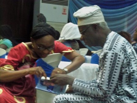 Professor Adenike Osofisan introducing her husband's book to Bookseller MD, Kolade Mosuro