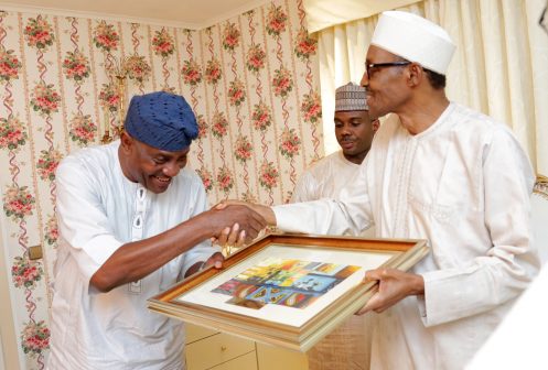 President Muhammadu Buhari presenting a parting gift to the out going Inspector General of Police, Mr Solomon Arase