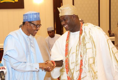 President Muhammadu Buhari in a hand shake with the Ooni of Ife HRM Adeyeye Ogunwusi