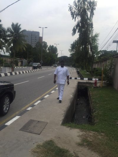 Senator Dino Melaye walking down Bourdillon Road in Ikoyi, Lagos on Saturday
