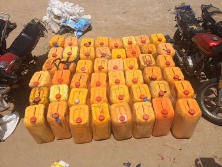 Plastic kegs of fuel, motorcycles and other items seized from the fleeing Boko Haram terrorists