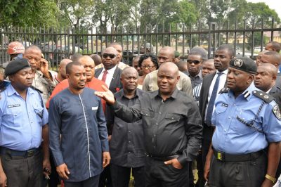 Governor Nyesom Wike (2nd right) inspecting the burnt INEC office at Bori