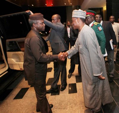 Vice President Yemi Osinbajo (left) on his way to the AU Summit in Kigali, Rwanda, shakes an official from his office