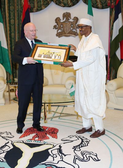 President Muhammadu Buhari presents a parting gift to the Outgoing US ambassador to Nigeria, Mr James F. Entwistle during a farewell audience with the President at the State House in Abuja.