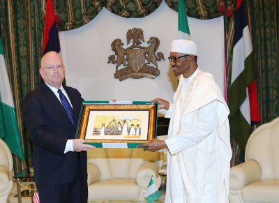 President Muhammadu Buhari presents a parting gift to the outgoing US ambassador to Nigeria, Mr James F. Entwistle during a farewell audience with the President at the State House in Abuja.