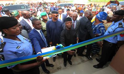Vice President Prof. Yemi Osinbajo SAN cutting the tape at the commissioning of the Official residence of the DPO at the New Divisional Headquarters of The Nigeria Police Force at Ilara-Mokin.