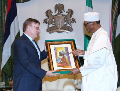  R-L:  President Muhammadu Buhari presents a parting gift to the outgoing Canadian High Commissioner to Nigeria, Mr Perry John Calderwood  during a farewell audience with the President at the State House in Abuja. 