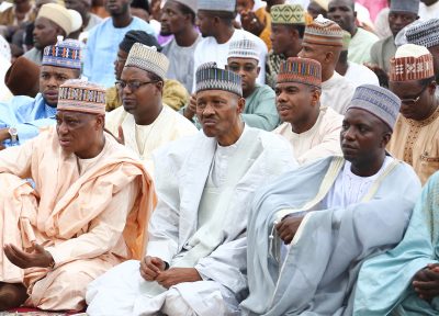 President Muhammadu Buhari (M) flanked by the Minister of Defence, Brig Gen Mansur Mohammed Dan-Ali (left) and others at Mambilla Barrack to mark the Eid Eld Fitri celebration in Abuja. 