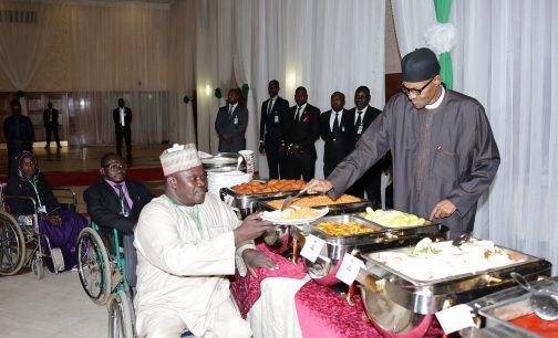 President Muhammadu Buhari serving one of the IDPs during the breaking of fast