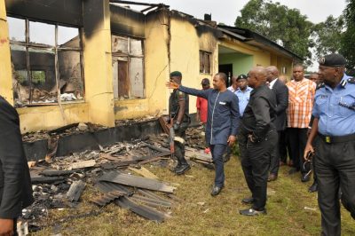 Governor Wike and other officials of government during an inspection of the burnt INEC office at Bori