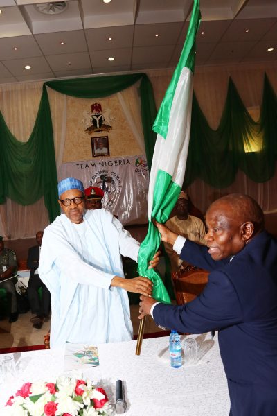 President Muhammadu Buhari presenting the Nigerian flag to the President of Nigeria Olympic Committee (NOC), Engr. Habu Gumel at the State House in Abuja.