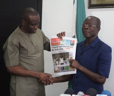 Mr Fidelis Anosike, Publisher Daily Times (left) presents a copy of the newspaper to Governor Adams Oshiomhole of Edo State during the visit of the management staff of Daily Times to Governor Oshiomhole, on Thursday.