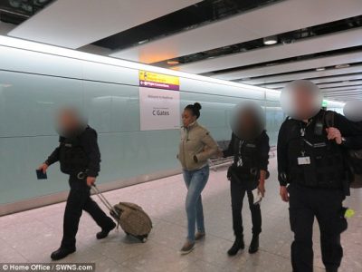 Franca Asemota being escorted by British policemen after her deportation