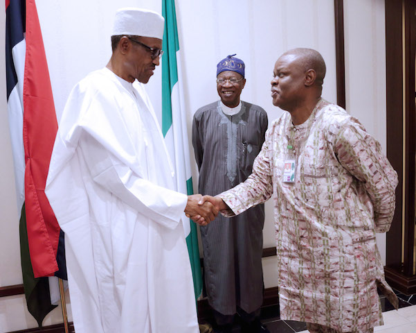 President Muhammadu Buhari in a handshake with Mr. Justin Abuah, Director Information, State House during the breaking of Ramadan Fast with State House Press Corps at the Villa.